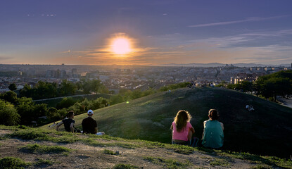 We all watch the sunset over the big city