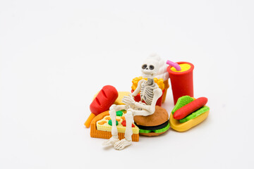 Fototapeta na wymiar Skeleton and foods, enjoy eating until death