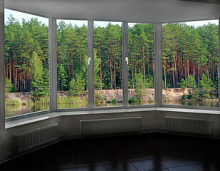 window in modern room with panoramic view to forest lake