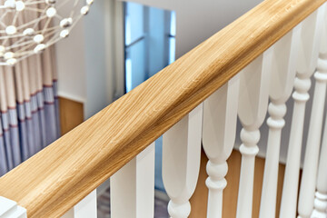 White balustrade. Wooden railing of a balcony with white balusters