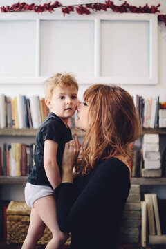 Mother whispering into her sons ear