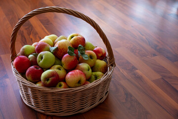 a basket of apples is on the floor
