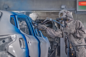 employee body painting workshop carries out painting of the internal elements of the car.