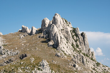 Fototapeta na wymiar Tulove grede are a strange karst phenomenon on Velebit Nature Park. This karst formation consists of towers, pillars and cracks. Rocky ridge of extremely steep slopes built of limestone.