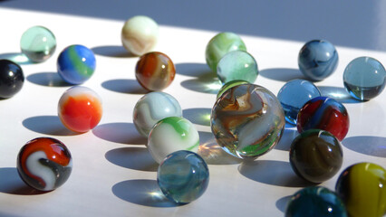 Light Reflecting in Colorful Glass Marbles on a White Surface