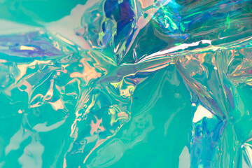 Mint colored holographic background. Wrinkled foil surface. Soft focus abstract backdrop.