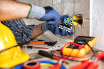 Electrician at work with safety equipment on a residential electrical system. Electricity.