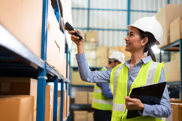 Warehouse woman staff use bar code scanner checking stock and supply on site