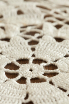 Close-up of vintage crochet doily on dark background