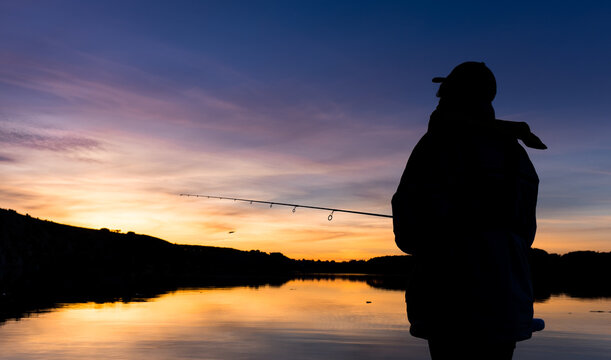 Fisherman against an evening sky