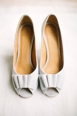 
Light-colored women's suede open-toed shoes. Bride's shoes. Selective focus. 
