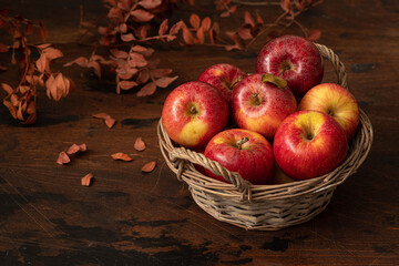 Fresh  Apples in basket on wooden background.