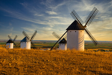 Old spanish windmills on a sunny day with clouds