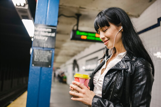 Woman waiting train in a subway station
