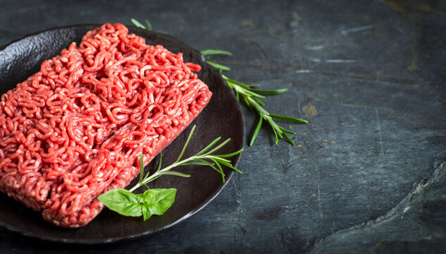 Fresh raw minced meat on the stone background