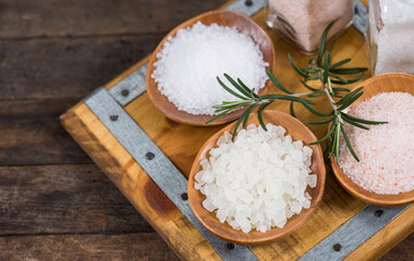 Fototapeta na wymiar Different types of salt in the wooden bowl