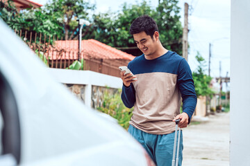 Asian casual man using smartphone to call taxi with application.