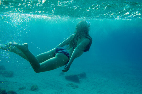 Underwater Photo Of Woman In Bikini Diving In The Sea