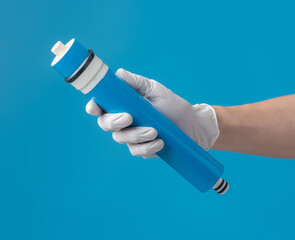 Filters for Drinking Water,Hand holding water filter cartridge on blue background