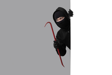 Burglar concept,Masked thief in balaclava with crowbar on gray background