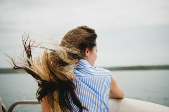 girl on lake with wind blowing through hair