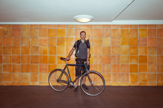 Bicycle Messenger Posing With His Bike