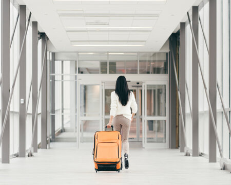 Girl with a suitcase in a hallway