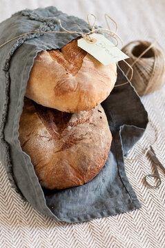loaves of bread wrapped by a towel