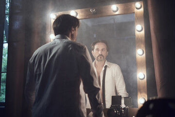 cinematic photo shoot of the confident actor celebrity look in foggy loft room