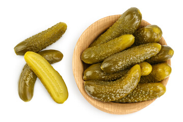 Marinated pickled cucumber in wooden bowl isolated on white background with clipping path and full depth of field. Top view. Flat lay