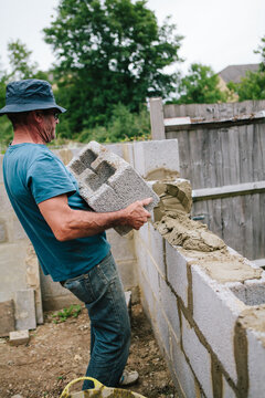 Builder working on a construction site building a wall