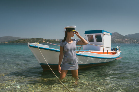 Attractive Girl In Front Of Small Boat In The Sea