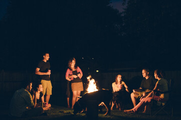 Family Pet and Friends Gathered Around a Campfire