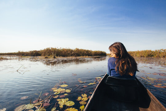 Woman On A Mokoro Canoe In The Okavango Swamp