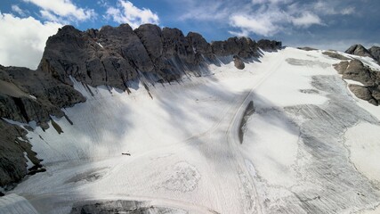 Fototapeta premium Amazing aerial view of Marmolada Glacier from drone, Dolomite Mountains, Italy