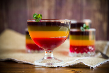 Sweet multi-colored fruit puff jelly in a glass cup