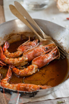 prawns in a pan with honey and rosemary