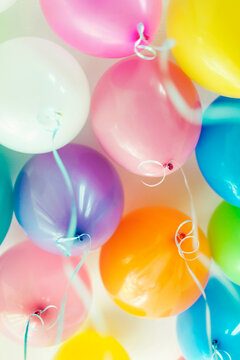 Bunch of floating mixed colored balloons and strings