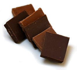 Chocolate cubes, milk and dark, bitter chocolate bar pieces on white background, close-up view.