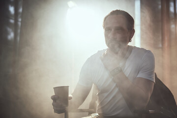 cinematic photo shoot of the confident actor celebrity look in foggy loft room