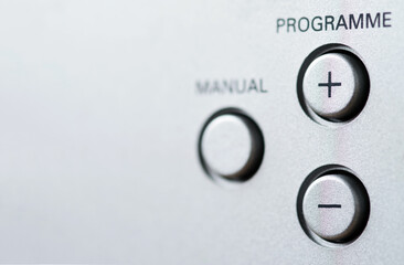 Program selection buttons with plus and minus signs and manual mode button. Selective focus.