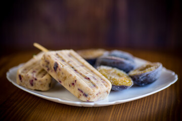 plum sweet homemade ice cream on a stick with slices of plum inside, in a plate