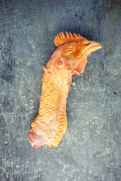 A cut off chicken's head with his eyes closed