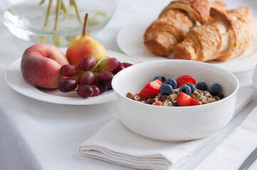 muesli fresh fruit and croissant breakfast