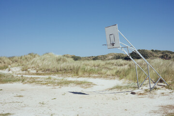 Basketball hoop on a desert beach