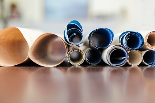 Antique scrolls rolled up on a table.
