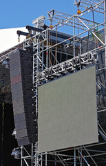 speakers hanging for an outdoor concert