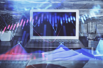 Financial graph colorful drawing and table with computer on background. Double exposure. Concept of international markets.