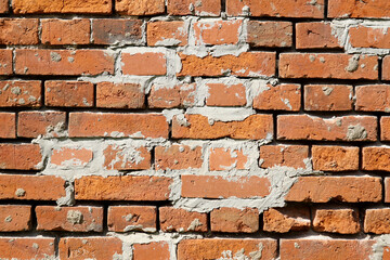  The old brick wall is repaired with new bricks to replace the lost ones.