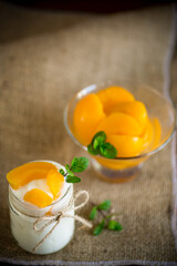 homemade sweet yogurt with slices of pickled peaches in a glass jar